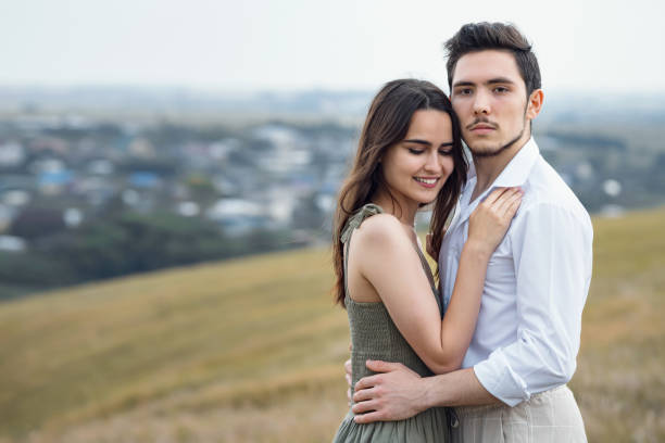istock Courageous man and positive woman pose on hill slope top 1651069974