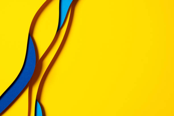 istock Abstract colored paper texture background. Minimal paper cut composition with layers of geometric shapes and lines in light blue, navy blue, yellow colors 1651122516
