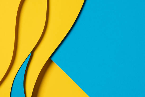 istock Abstract colored paper texture background. Minimal paper cut composition with layers of geometric shapes and lines in light blue, navy blue, yellow colors 1651123671