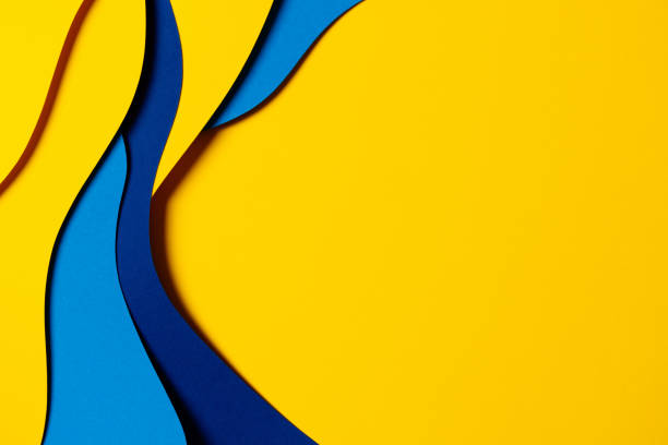 Abstract colored paper texture background. Minimal paper cut composition with layers of geometric shapes and lines in light blue, navy blue, yellow colors