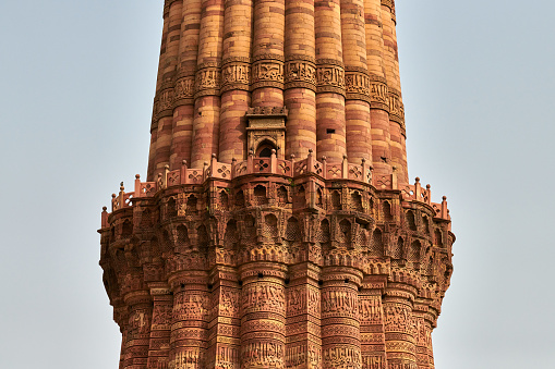 Close up view of Qutb Minar minaret tower part Qutb complex in South Delhi, India, big red sandstone minaret tower landmark popular touristic spot in New Delhi, indian architecture building