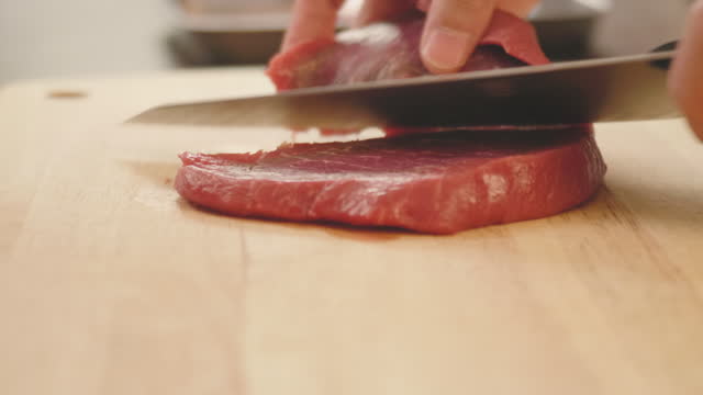 hand cut beef steak on wooden chopping board