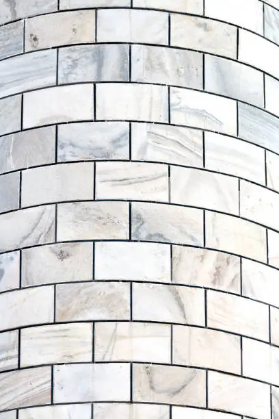 Photo of White marble bricks of Taj Mahal minaret towers, close up ivory white marble bricks background