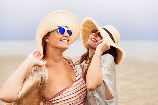 Two Happy And Smiling Female Friends In Summer Clothes