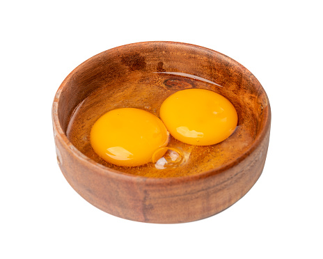 Two Broken Eggs in Bowl Isolated, Raw Yolk and White, Fresh Broken Organic Chicken Eggs on White Background