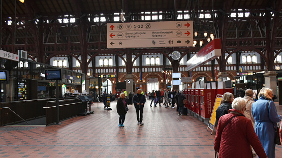 Copenhagen, Denmark - May 17, 2023:Scene Of People Walking, Departing After Arrival With Train, Buying Train Ticket And More At Copenhagen Central Railway Station