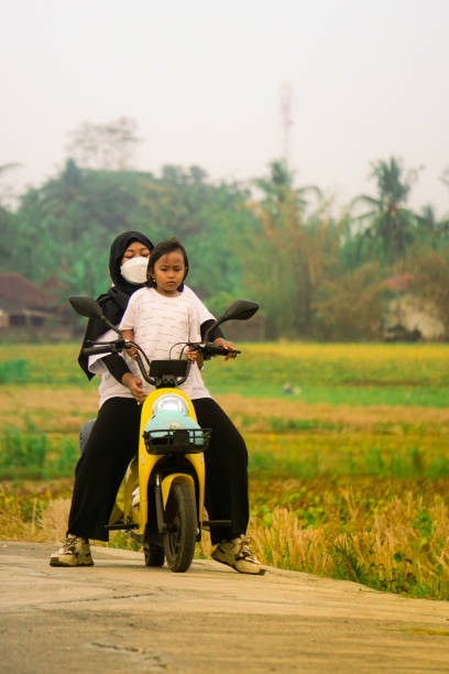 Yogyakarta, Indonesia - August 06, 2023: Cycling with an Electric bike at Geblek Menoreh View