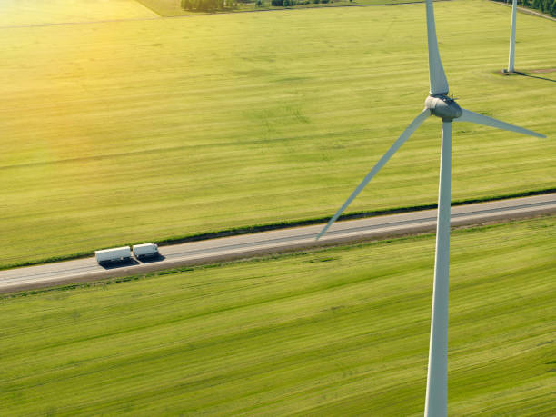 istock Truck on a highway through a rural landscape with wind turbines 1651184991