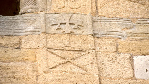 istock symbols engraved in stone of a facade 1651189973
