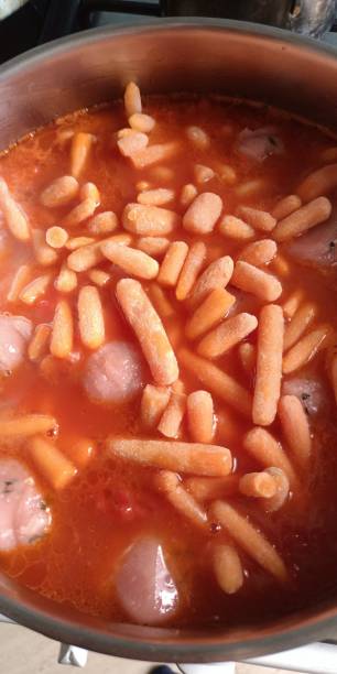 istock Small frozen mini carrots were poured into the soup with meat meatballs 1651201607