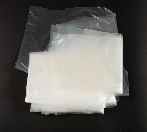 istock Folded White Plastic Bags on Black Background, Crumpled Plastic Bag after Shopping, Cellophane Packaging Waste 1651215288