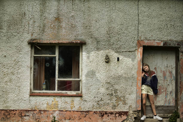 istock Primary age girl standing outside her house 1651216476