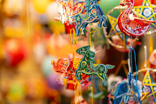 Decorated colorful lanterns hanging on a stand in the streets in Ho Chi Minh City, Vietnam during Mid Autumn Festival. Selective focus.