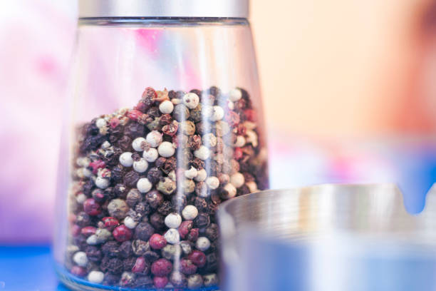 Pepper grains in a glass pot close up still