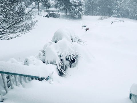 Snow snowdrift against a brick wall. Snow removal.