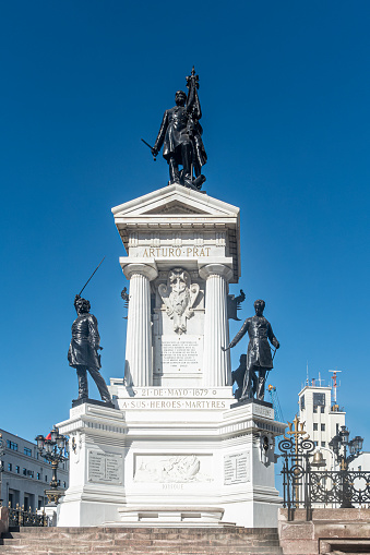 Valparaíso, Chile - 14th November 2022: Monument to the Heroes of Iquique in Plaza Sotomayor in Valparaíso, western Chile, South America. It honours the heroes who were killed in Chile's war with Peru (the War of the Pacific), in the Battle of Iquique and the Battle of Punta Gruesa which took place in May 1879. The statue was funded by public subscripton and  inaugurated in 1886. At the top is the Captain of the Esmerelda, one of the ships involved in the battle of Iquique, Arturo Prat, who is buried with some of his men underneath the monument.