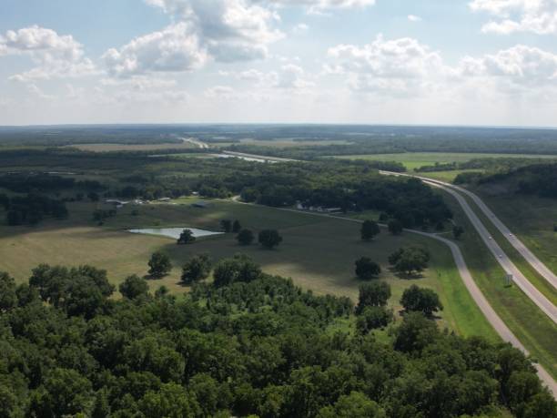 istock the highway is going past an open field and many trees 1651267429