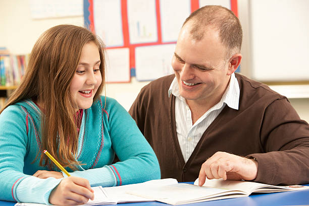 istock Pupil Studying in classroom with teacher 165126769