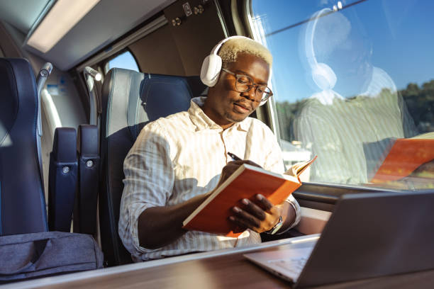 istock African American businessman writing notes in train 1651313059