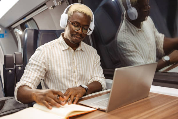 istock African American businessman writing notes in train at night 1651313151