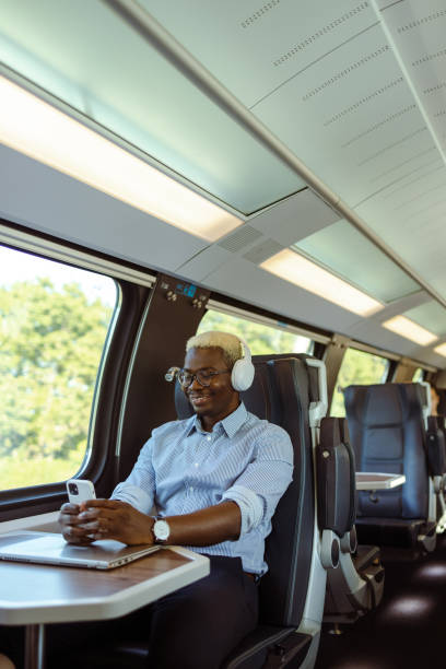 istock African American businessman using smart phone in train 1651313326