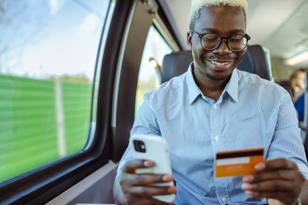 istock African American businessman using online payment services on smart phone in train 1651313327