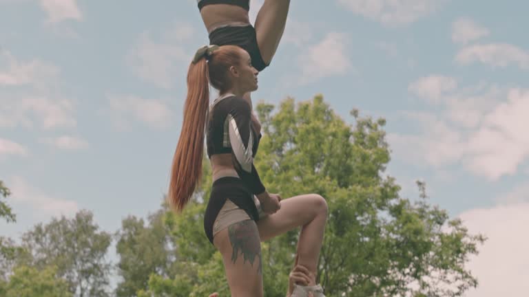 Cheerleaders Performing Two and Half High Pyramid