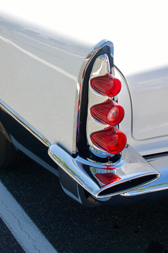 Closeup details of tail lights and rear fender of a vintage auto