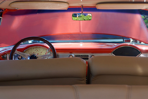 Interior view of a vintage auto dashboard from the rear seat
