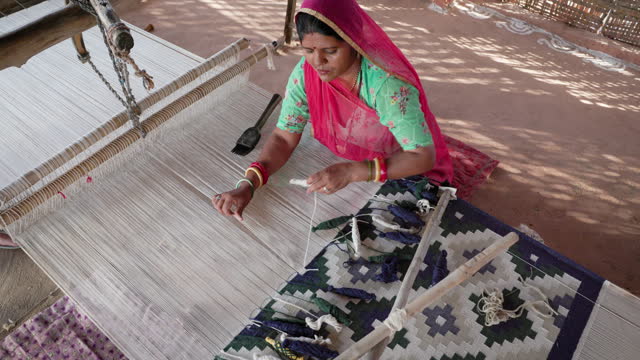 Indian woman weaving textiles (durry) in Rajasthan