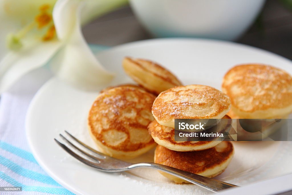 Dutch mini pancakes called poffertjes Dutch mini pancakes called poffertjes, sprinkled with powdered sugar Poffertjes Stock Photo