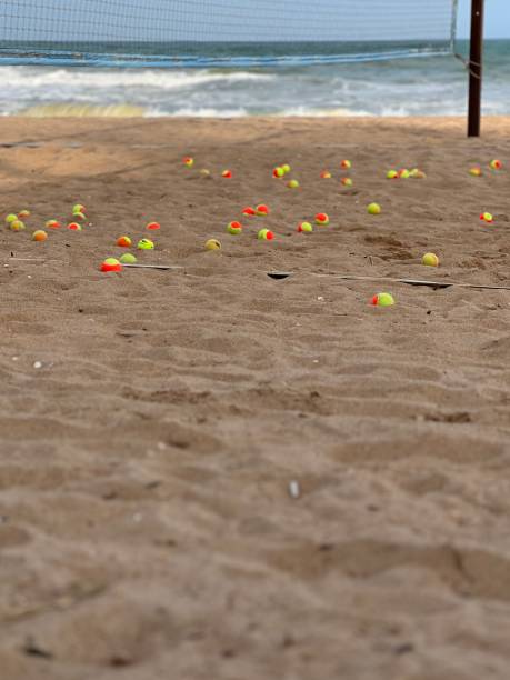 Many beach tennis balls on the beach sand