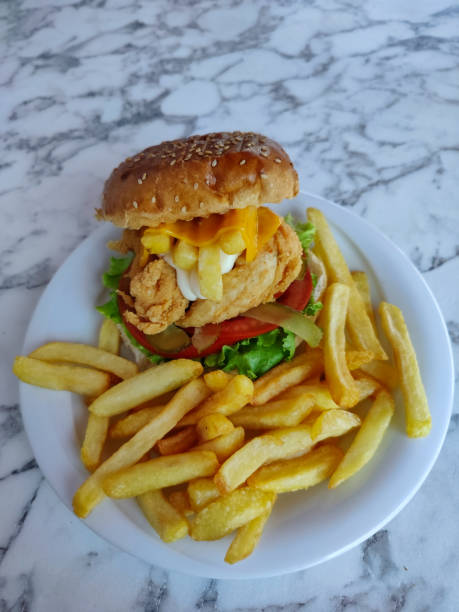 istock cheese chicken burger and fries 1651460547
