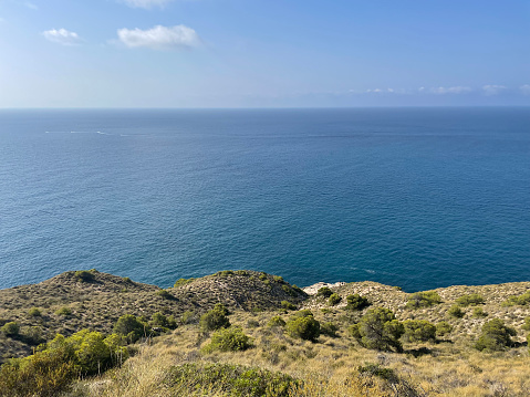 Landscape of cliff. Between Benidorm beach, Finestrat bay and Villajoyosa, Alicante. Summer vacational destination. Travel concept. High quality photo