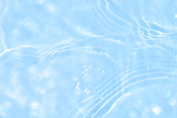 istock Blue water with ripples on the surface. Defocus blurred transparent blue colored clear calm water surface texture with splashes and bubbles. Water waves with shining pattern texture background. 1651583304