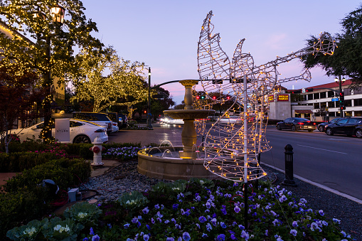 Highland Park Village, Texas, USA - November 20th, 2021: Christmas decoration of the trumpeting angel in the background of urban street