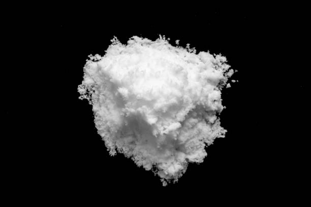 istock White snow isolated on black background close up 1651623699