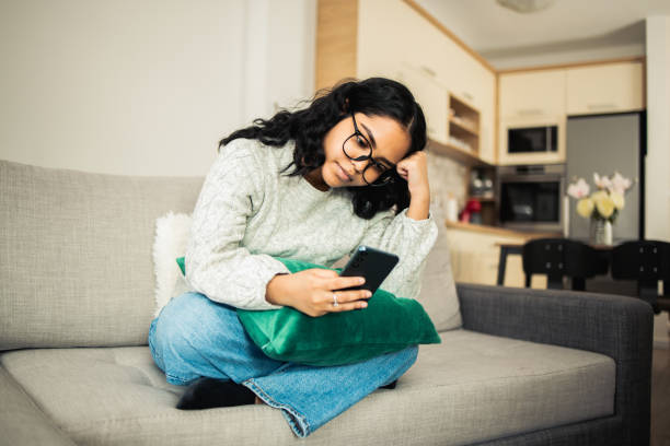 istock Girl relaxing at home and using smartphone 1651635116