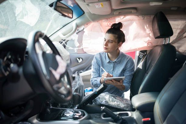 istock Insurence adjuster inspecting damages on the inside of a crashed vehicle. 1651641185