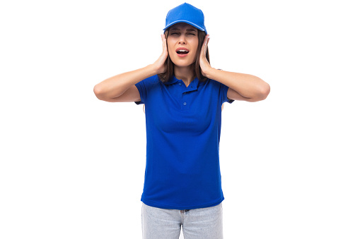 pretty surprised young woman in blue cotton t-shirt and cap with mockup isolated on white background with copy space.