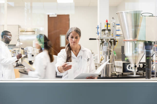 Scientist reads the test results to update her lab report