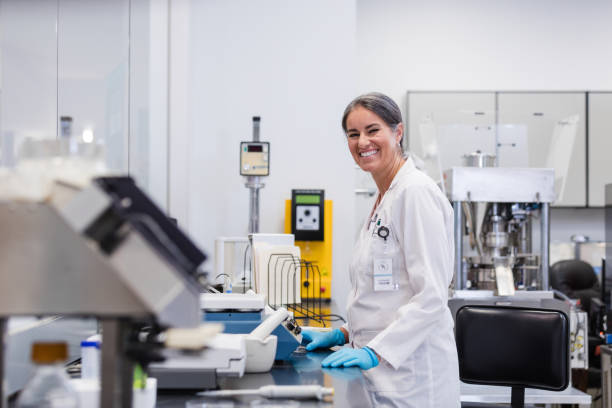 istock Mature female laboratory technician smiles for the camera 1651657173