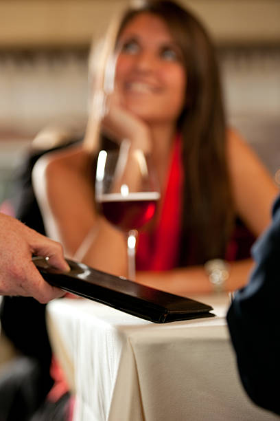 istock Waiter Hands Check to Customers on Date 165167142