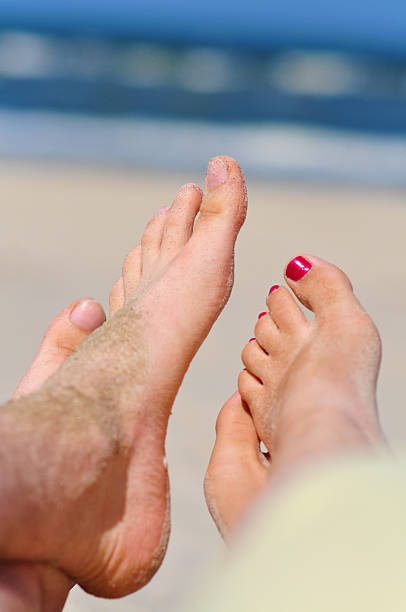 istock Couple at a beach - bare feet 165167344