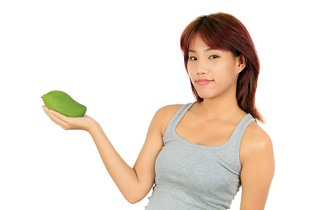 istock Isolated young asian woman with mango over white 165172957