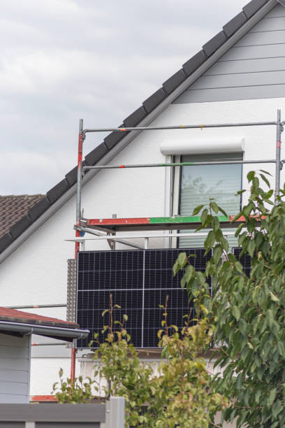 balcony power plant with rooftop house facade stock photo