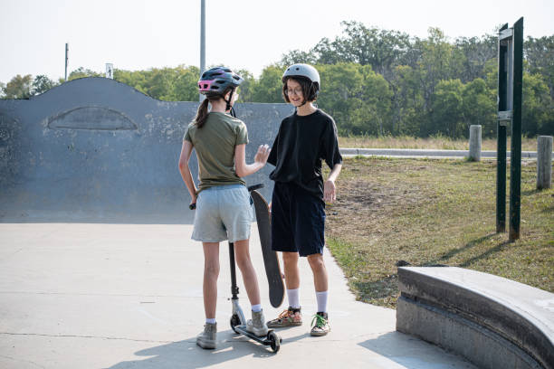 istock Siblings Embracing Fun: Skateboarding and Scooter Adventures 1651735531