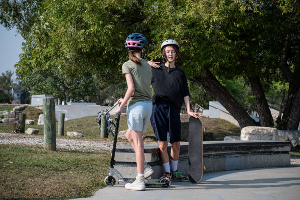 istock Siblings Embracing Fun: Skateboarding and Scooter Adventures 1651735533