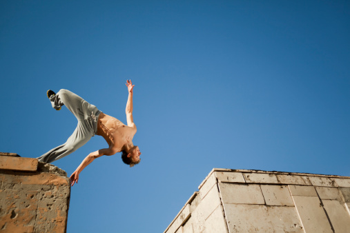 Street dancer performing somersault