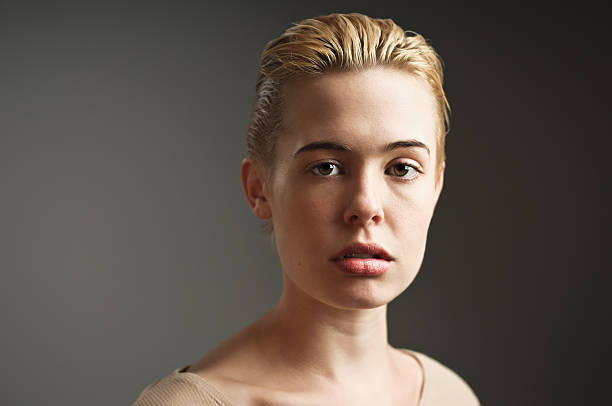 Portrait Sad girl with short bleach blonde hair. slicked back hair stock pictures, royalty-free photos & images